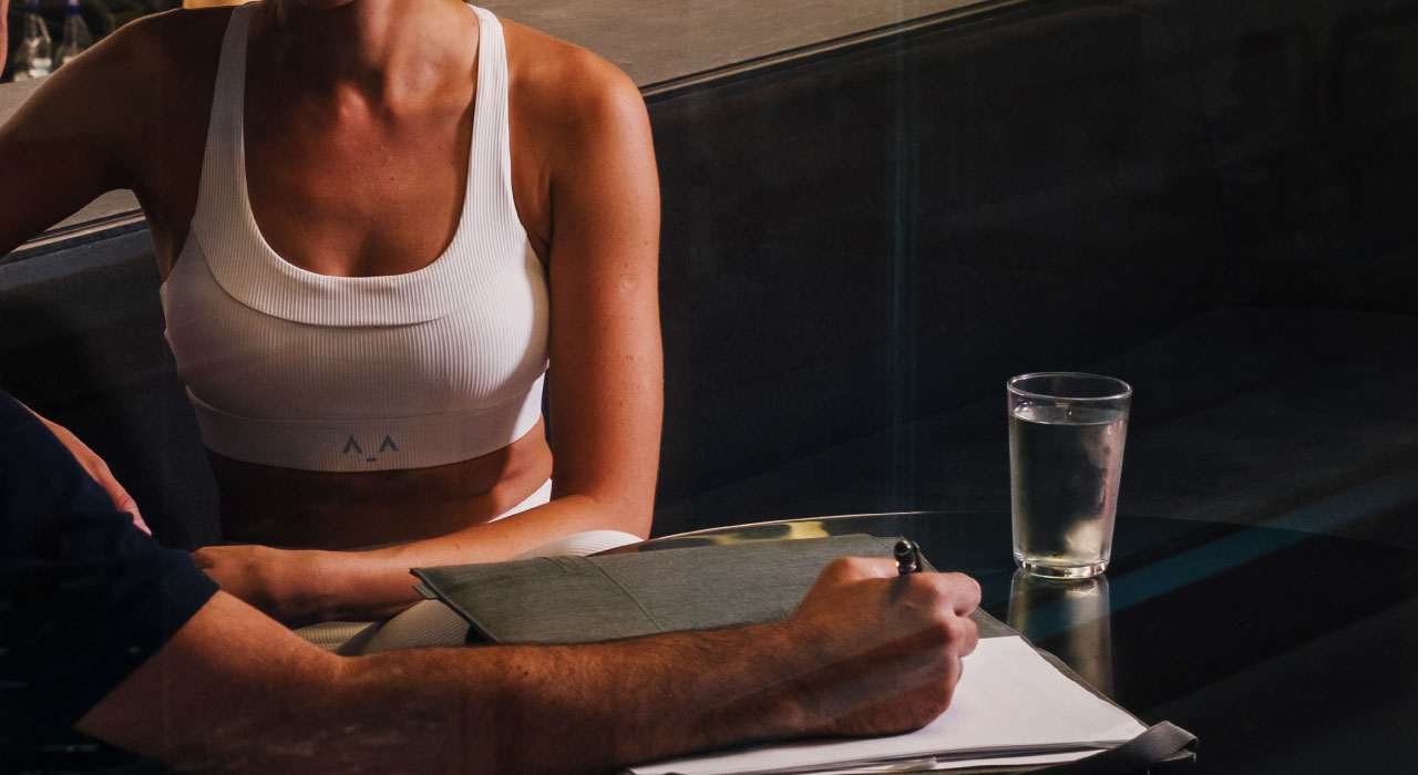 Holmes Place | woman sitting at a cafe table