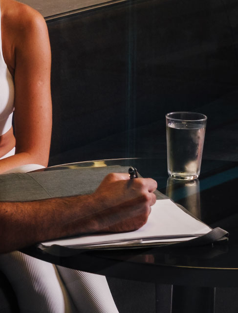 Holmes Place | man siting with woman, writing and a   glass of water